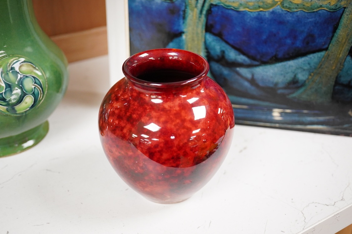 A Moorcroft for Liberty & Co. Flamminion Ware vase, and a smaller Moorcroft vase glazed in a mottled plum flambe, the first 20cm., also to include two Moorcroft reference books